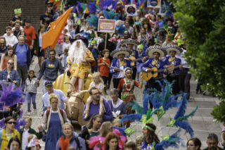 Together Parade opening the Basingstoke Festival. Image shows large group of communities wearing bright colours.