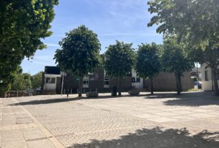 A paved area surrounded by trees.