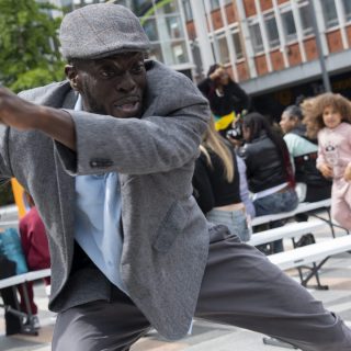 A man dressed like a grandad is dancing