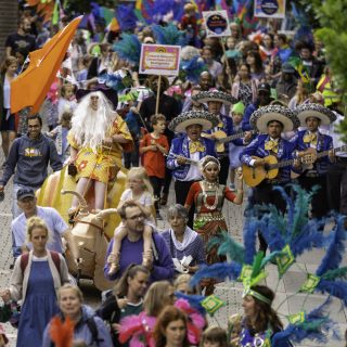 Together Parade opening the Basingstoke Festival. Image shows large group of communities wearing bright colours.
