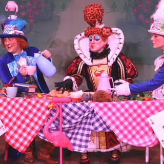 An alice in wonderland set up around the table.
